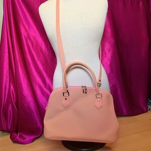 Very unique, baby pink latex like purse, remov strap,clean inside out